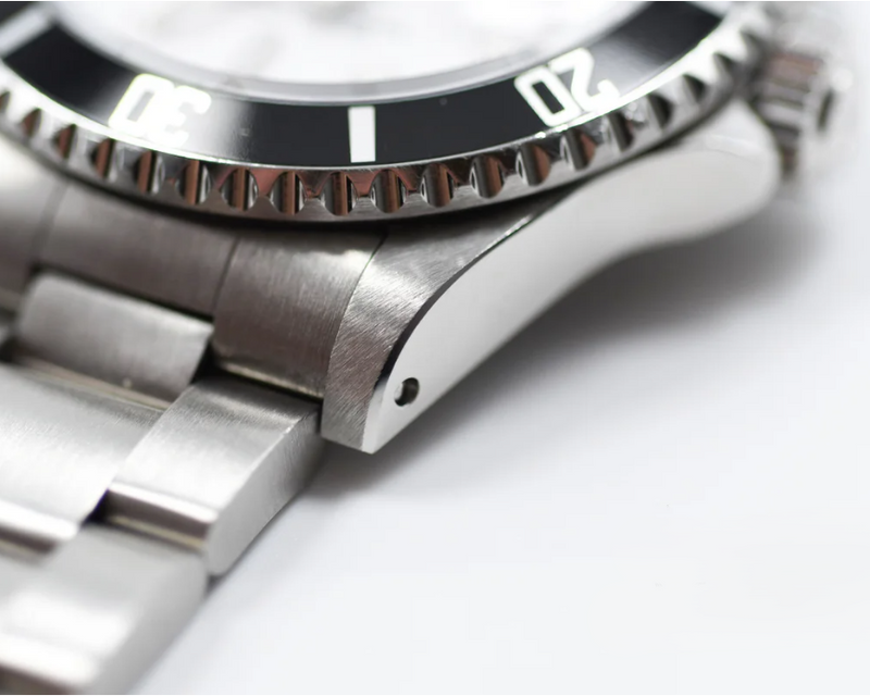 Close-up of a silver watch with a white background