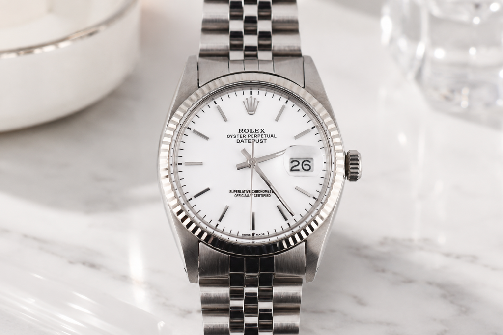Silver Rolex watch on a marble surface