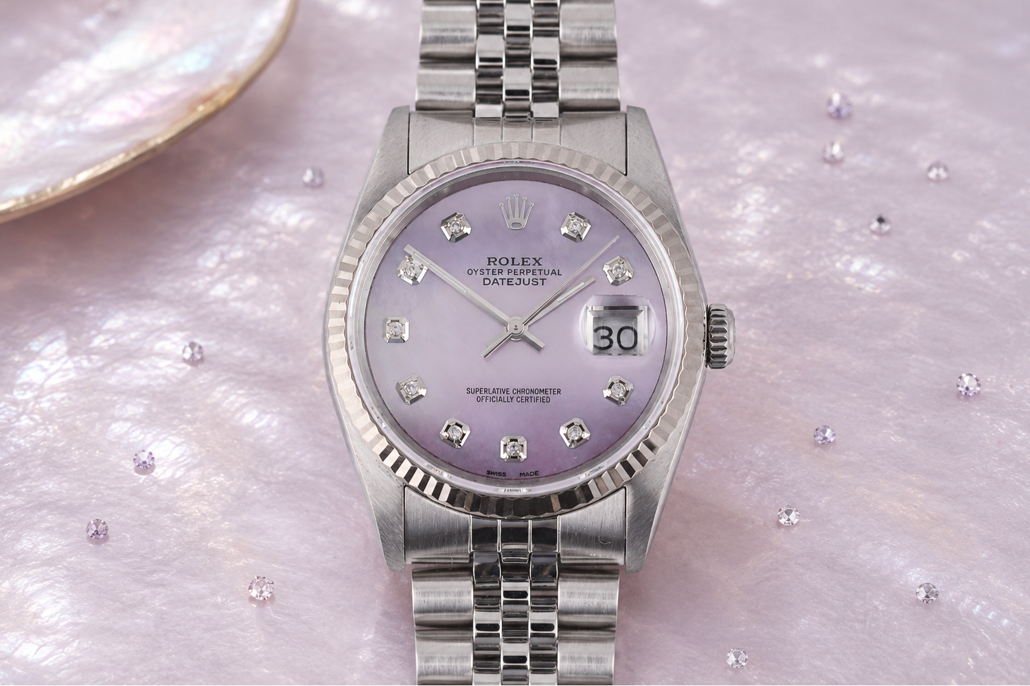 Silver watch with a purple face on a mother of pearl background