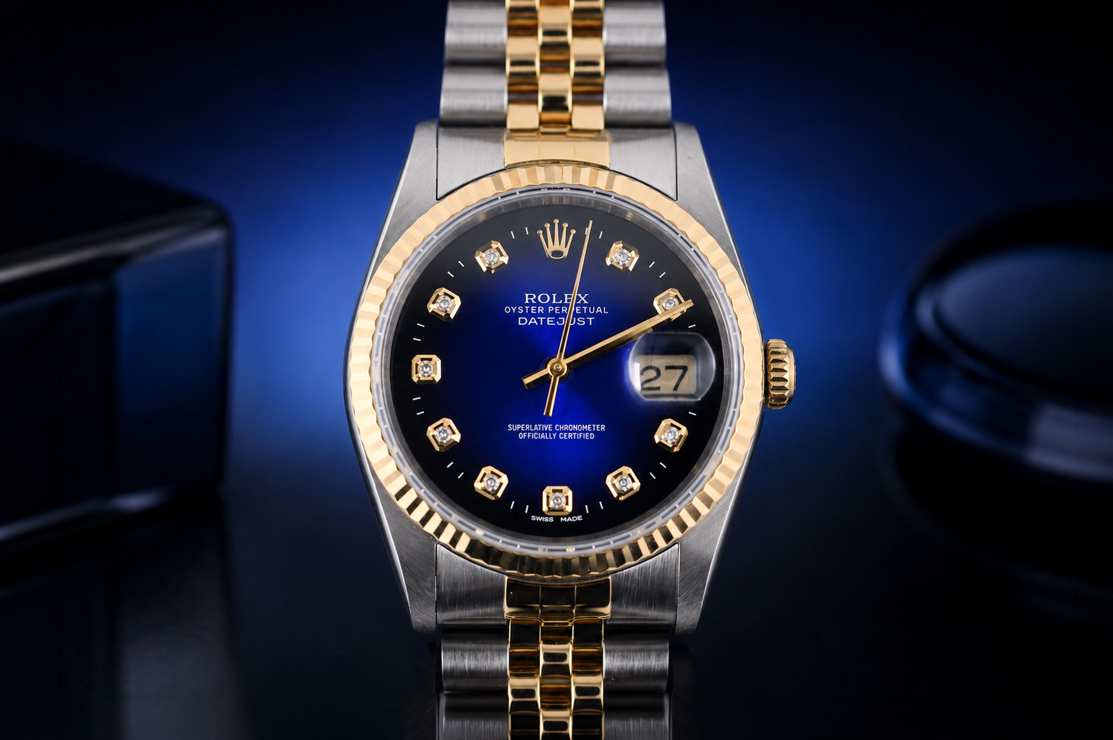 Luxury watch with blue dial and gold accents on a dark background