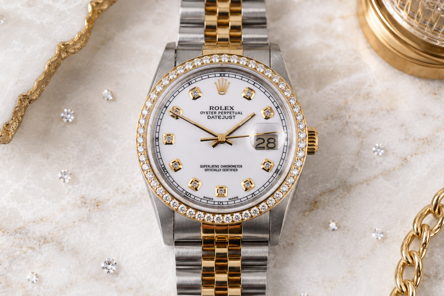 Luxury watch with diamond bezel on a marble surface