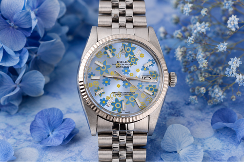 Silver watch with floral face on a blue floral background