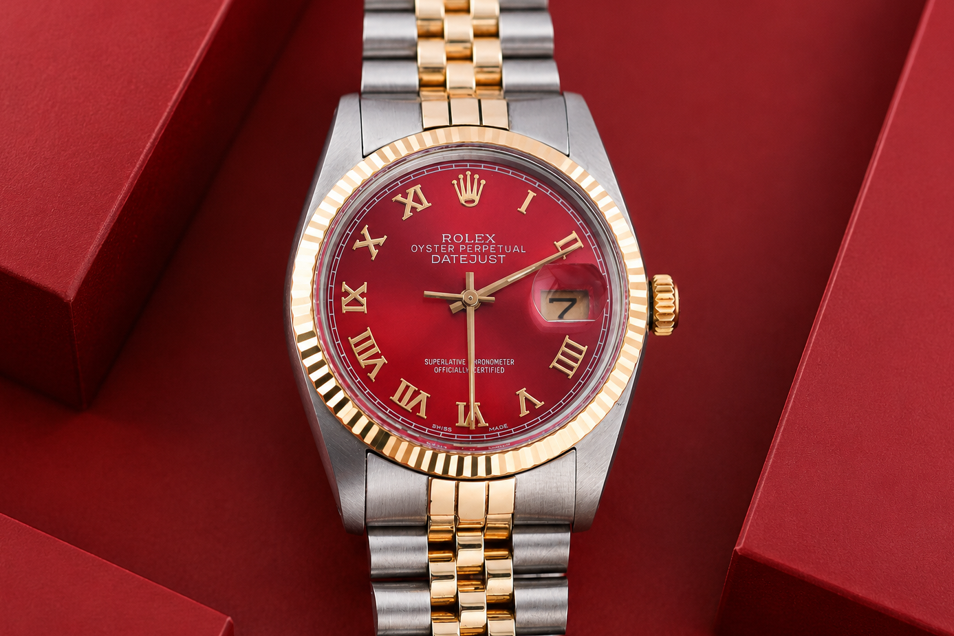 Luxury watch with red face and gold accents on a red background