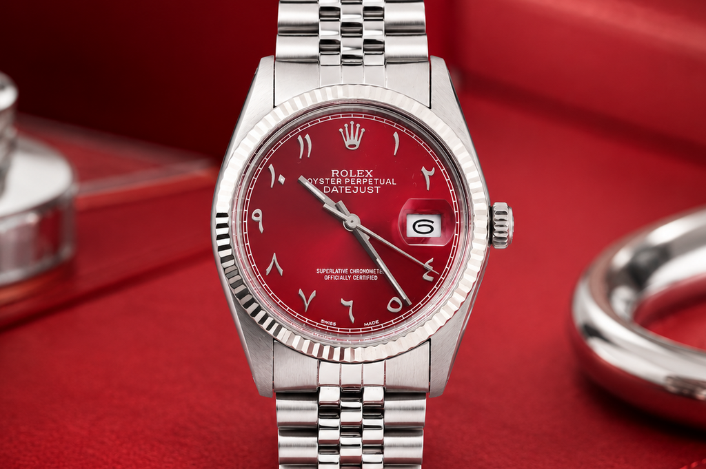 Silver watch with a red face on a red background