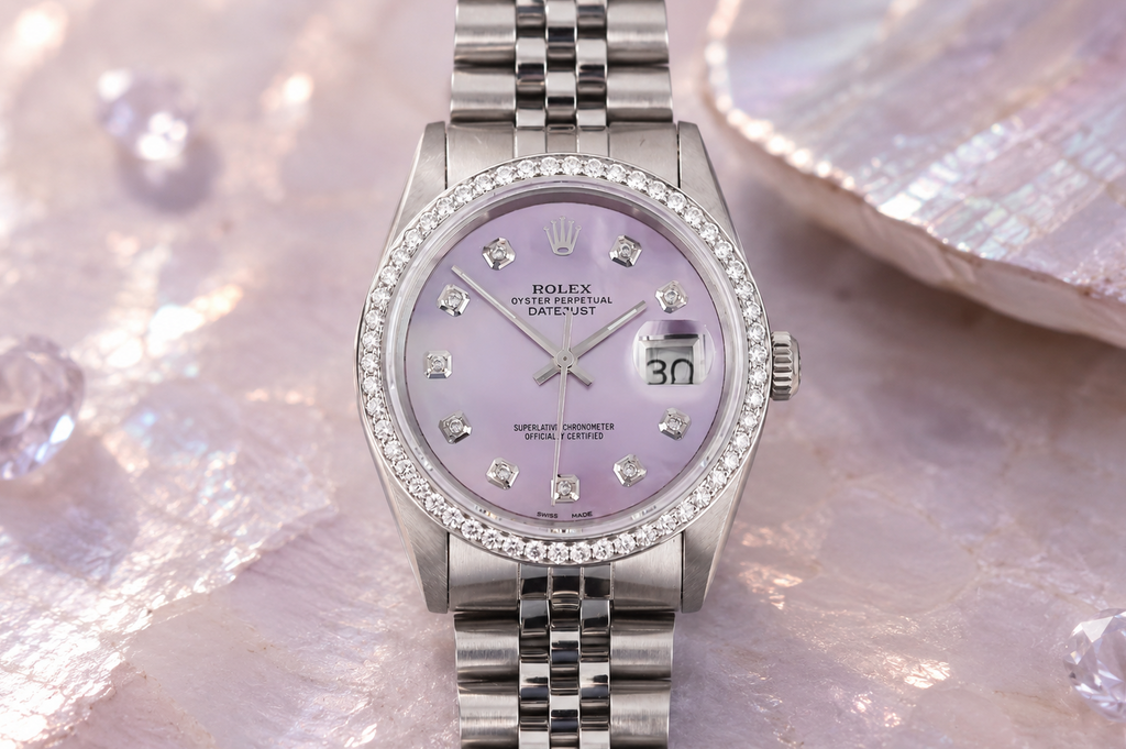 Silver watch with a purple face on a textured surface