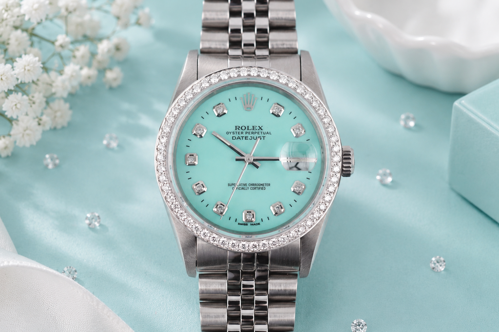Silver watch with a turquoise dial and diamond accents on a light blue background