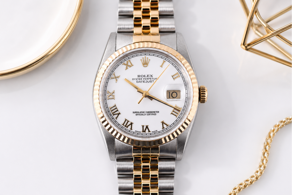 Luxury watch with gold and silver band on a white background