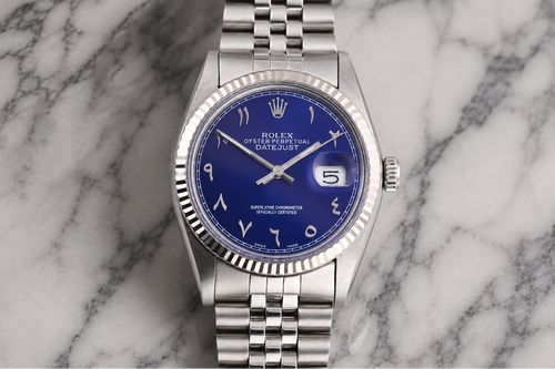 Silver watch with a blue face on a marble background
