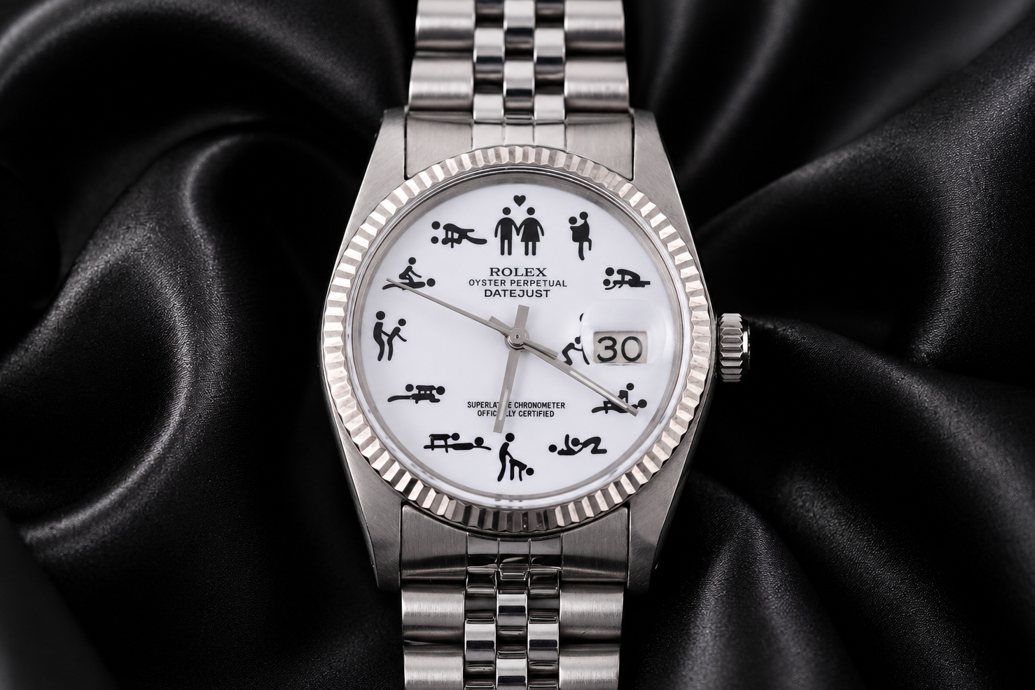 Silver watch with a unique face design on a black satin background
