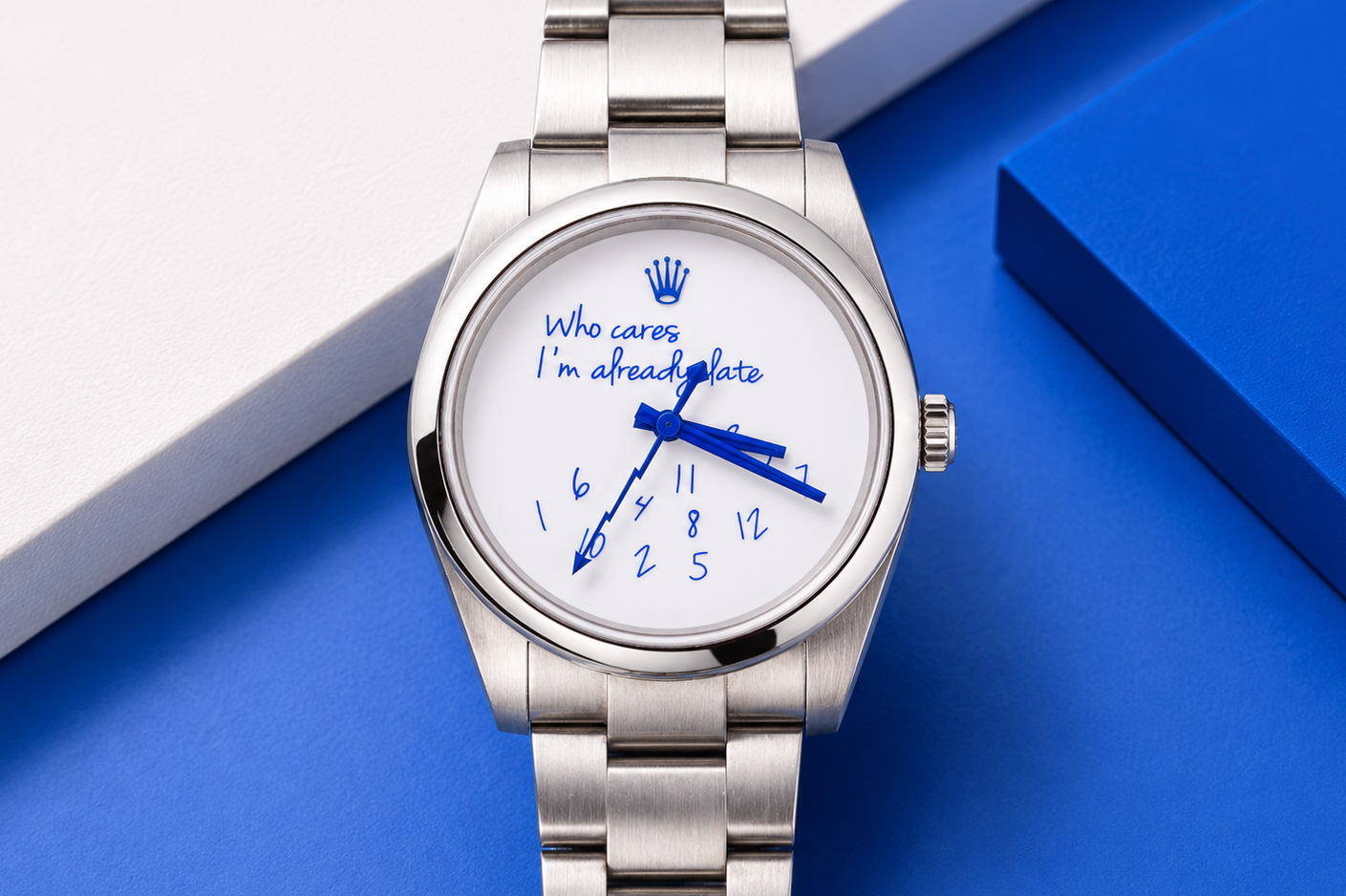 Silver watch with a white face displaying blue text on a blue background