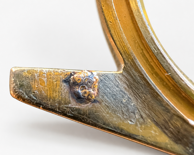 Close-up of a metal object with a detailed design on a white background
