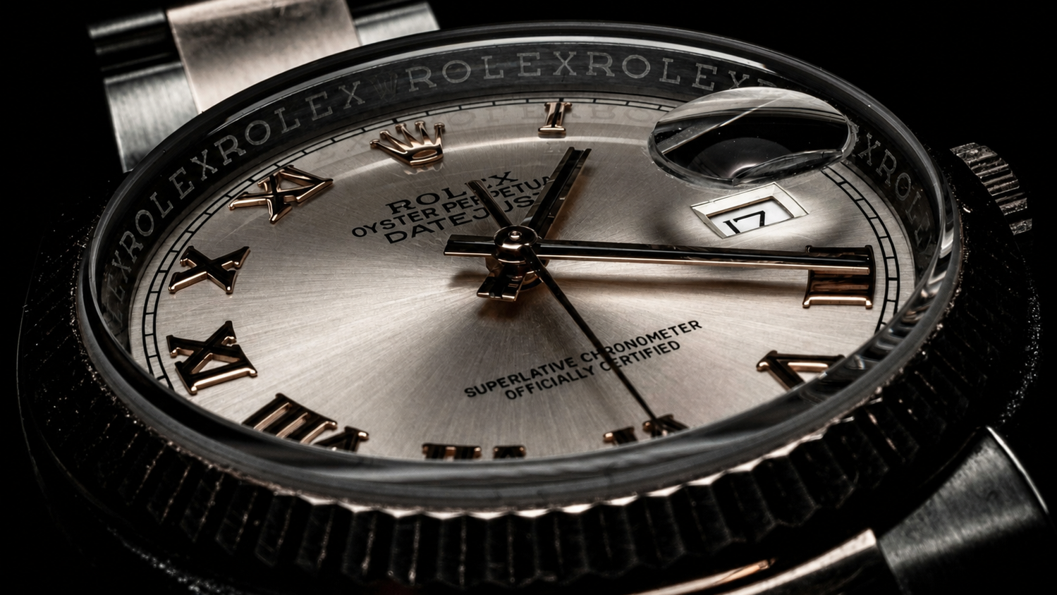 Rolex watch with silver dial and black case on a dark background