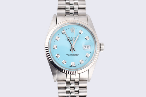 Silver watch with a light blue dial on a light gray background