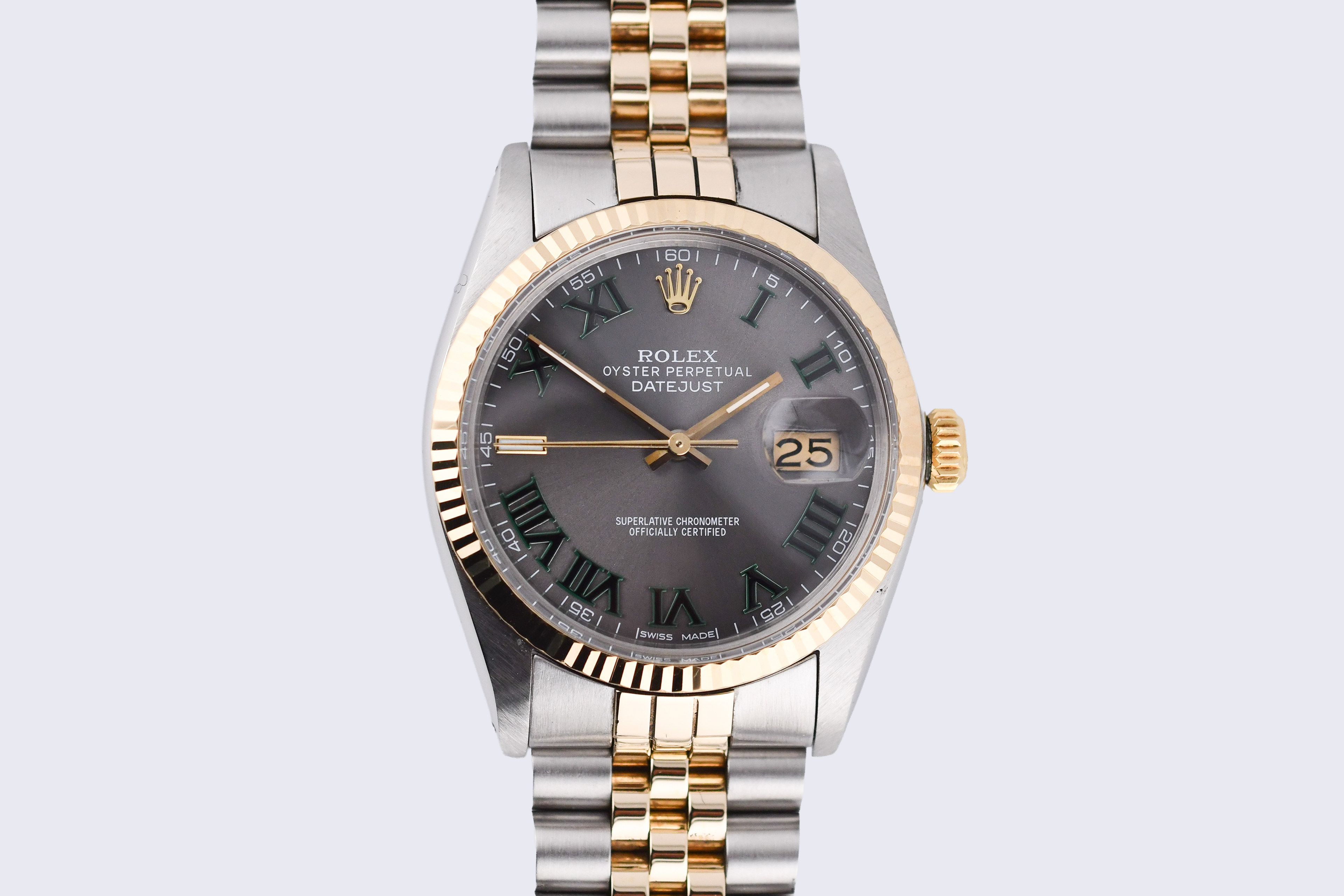 Luxury watch with silver and gold band on a light gray background