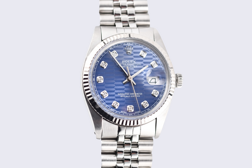 Silver watch with a blue face on a light gray background