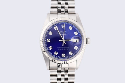 Silver watch with a blue face on a light gray background