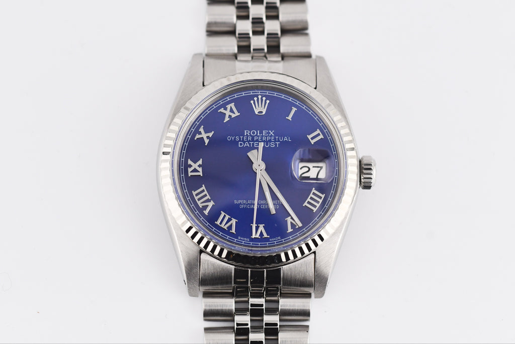 Silver watch with a blue face on a white background