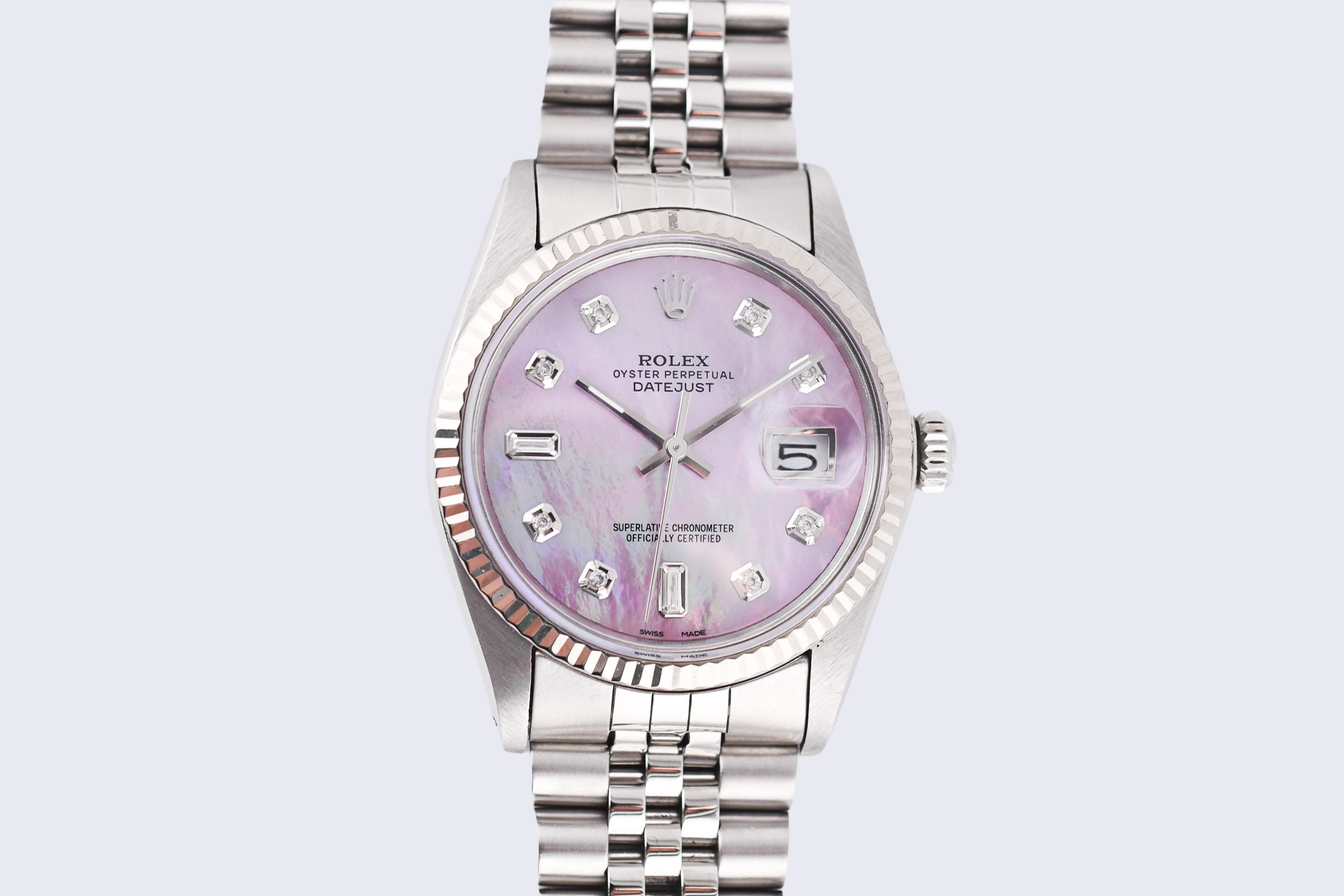 Silver watch with a pink face on a light gray background