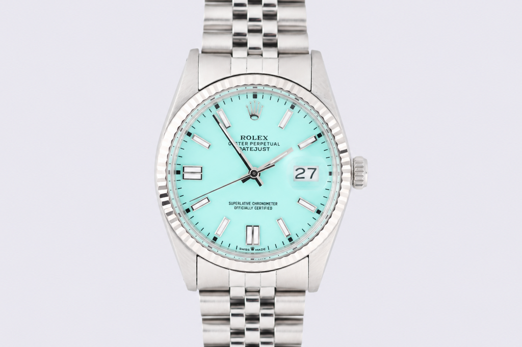 Silver watch with a light blue face on a light gray background