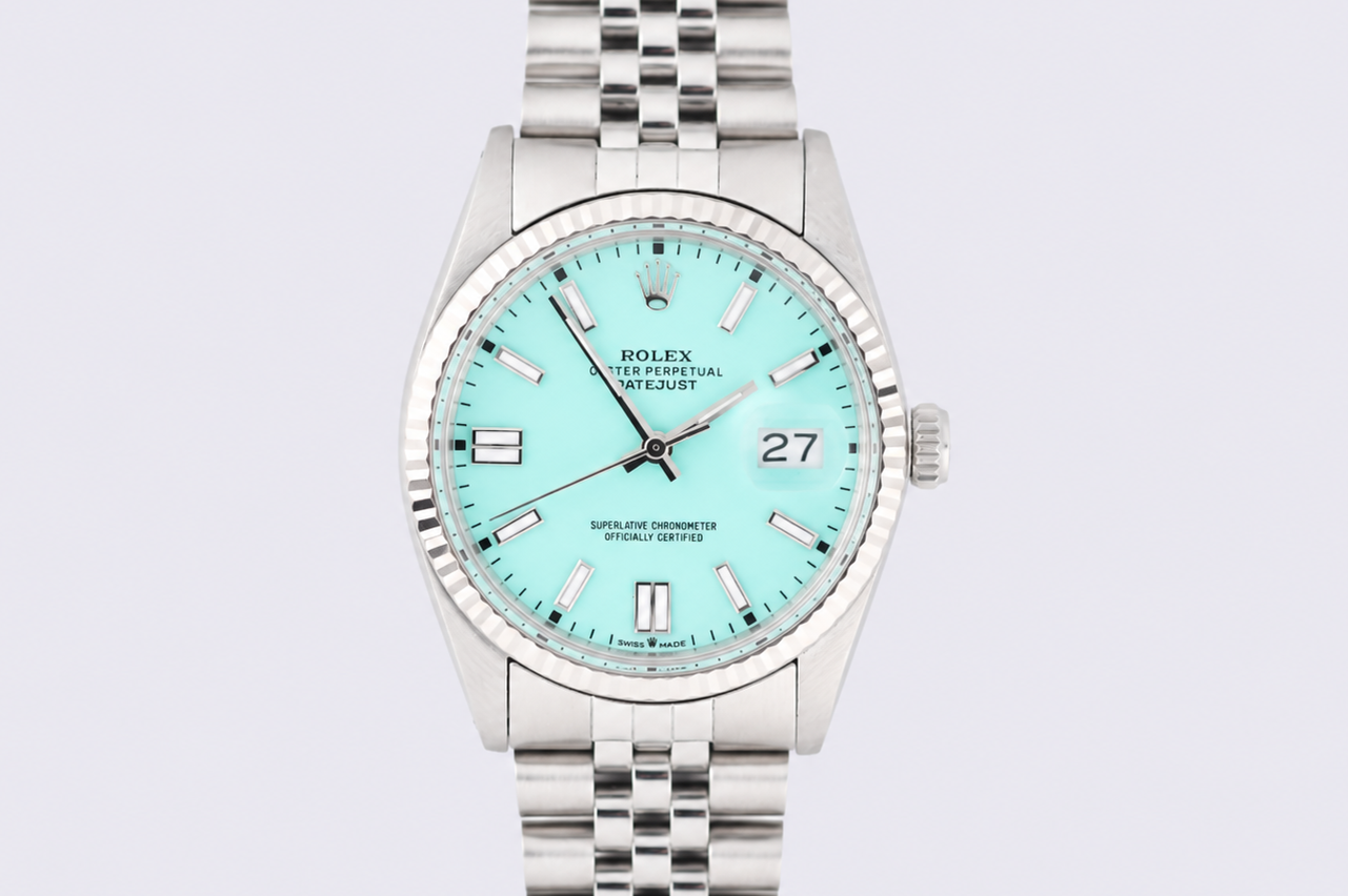 Silver watch with a light blue face on a light gray background