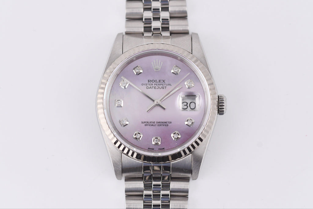 Silver watch with a purple face on a white background