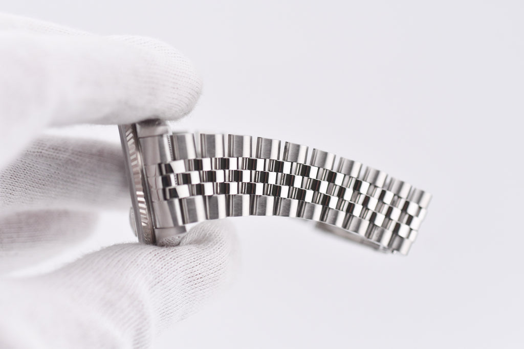 Metallic watch strap on a white background