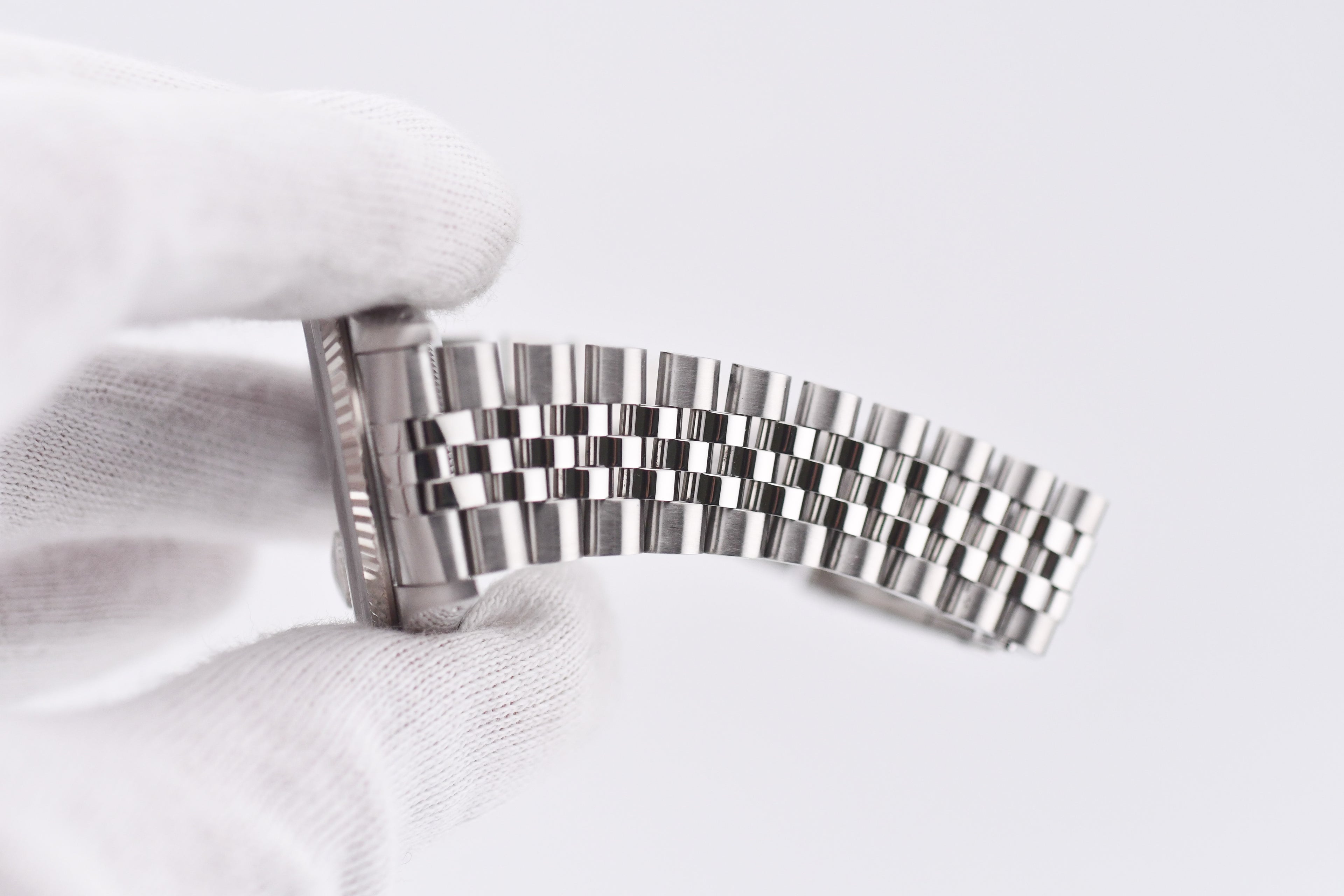 Metallic watch strap on a white background