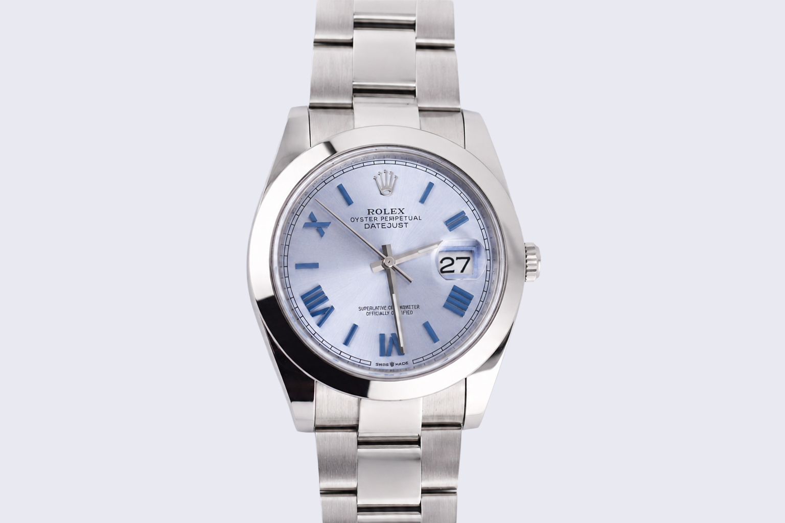 Silver watch with a white face on a light gray background