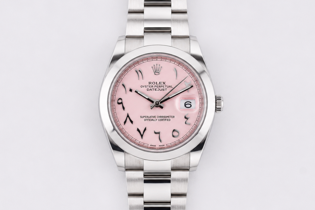 Silver watch with a pink face on a light gray background