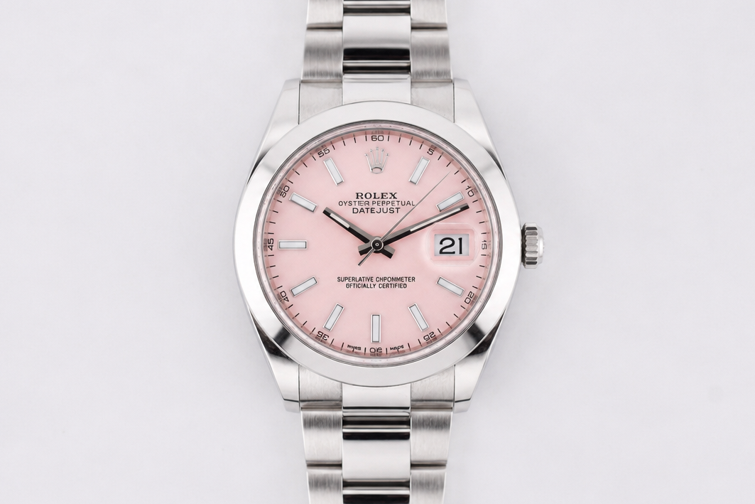 Silver watch with a pink face on a white background