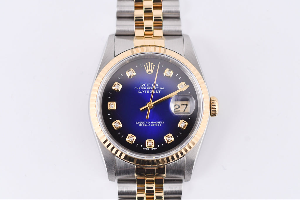 Luxury watch with a blue face and gold accents on a white background