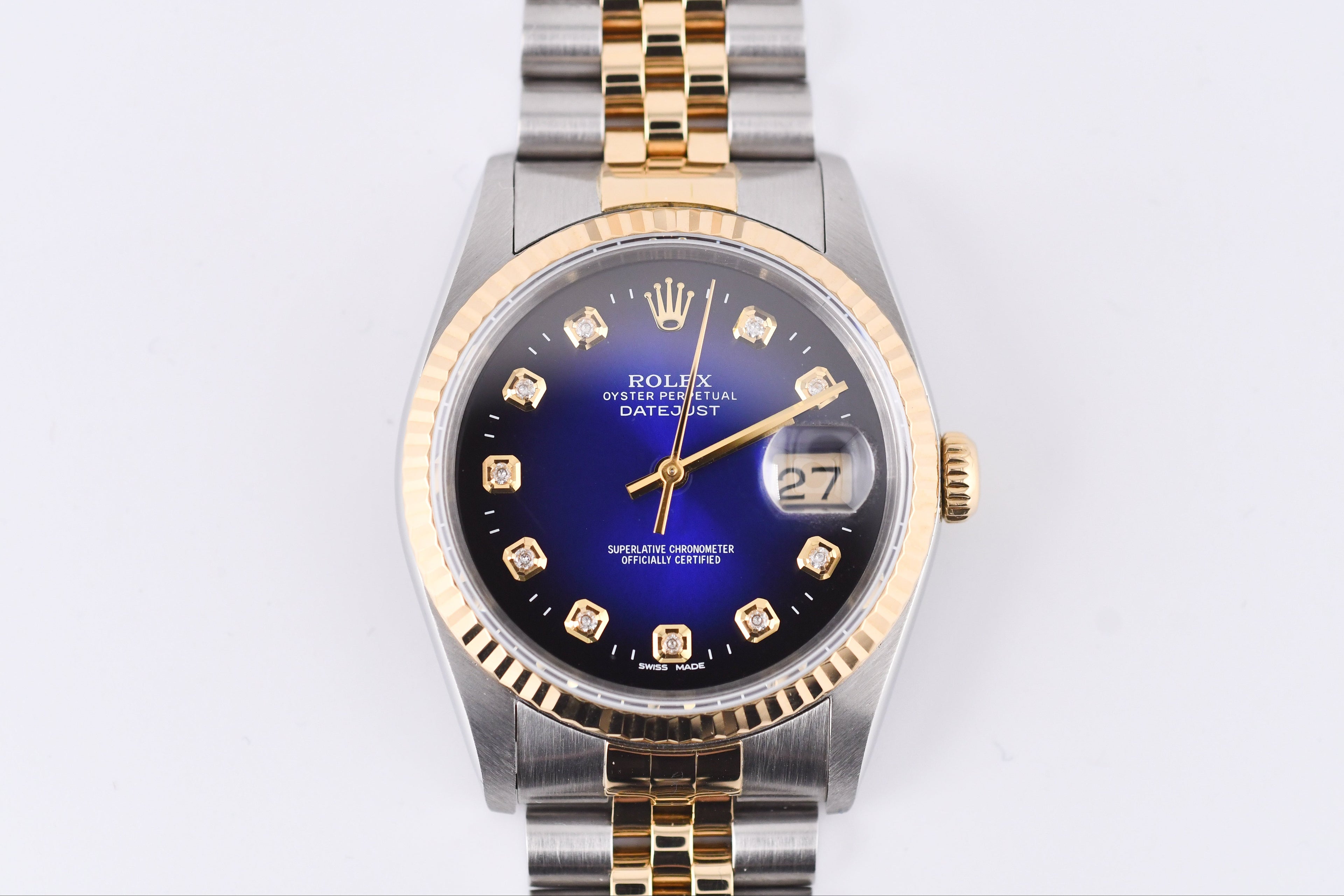 Luxury watch with a blue face and gold accents on a white background
