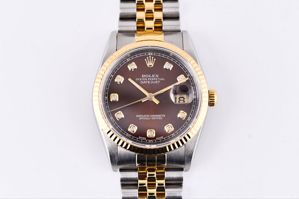 Two-tone Rolex watch with gold and silver band on a white background
