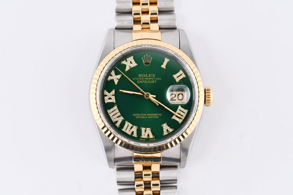 Rolex watch with green dial and gold and silver case on a white background