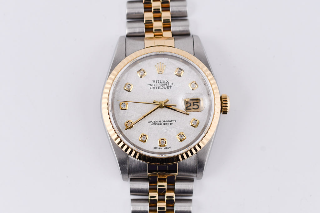Luxury watch with silver and gold band on a white background