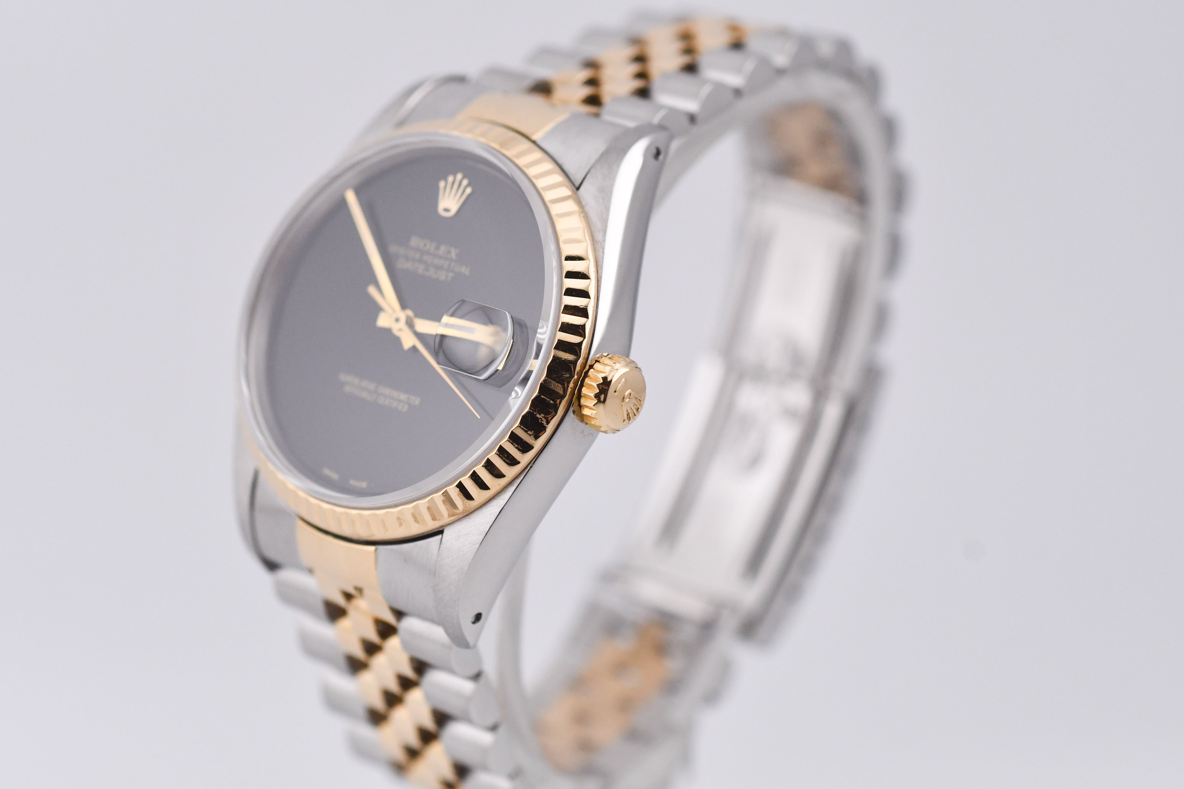 Two-tone watch with silver and gold band on a light gray background