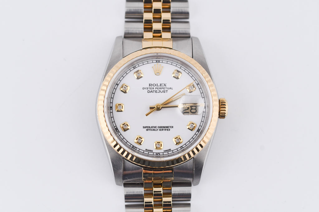 Two-tone watch with gold and silver band on a white background