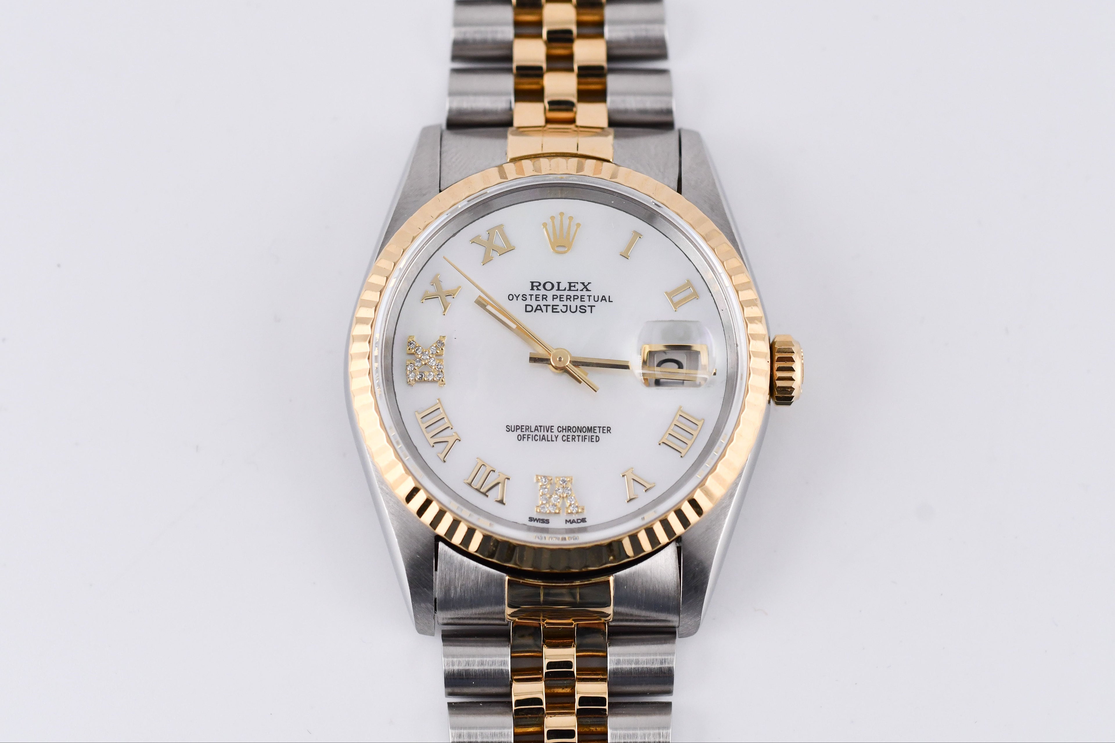 Two-tone Rolex watch with silver and gold band on a light gray background