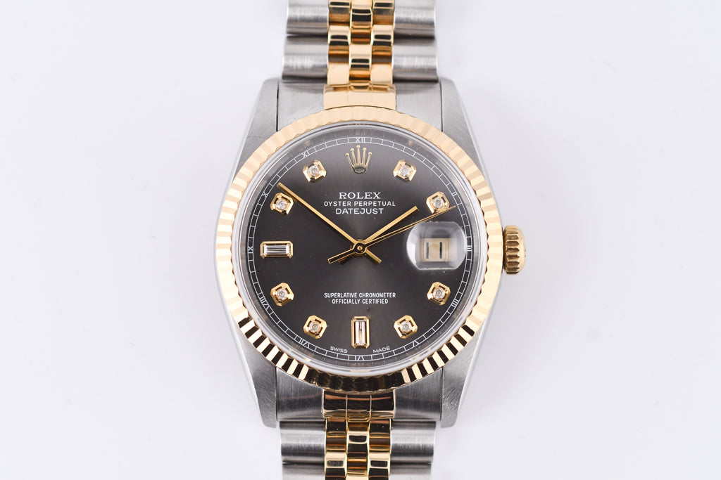 Rolex watch with gold and silver band on a white background