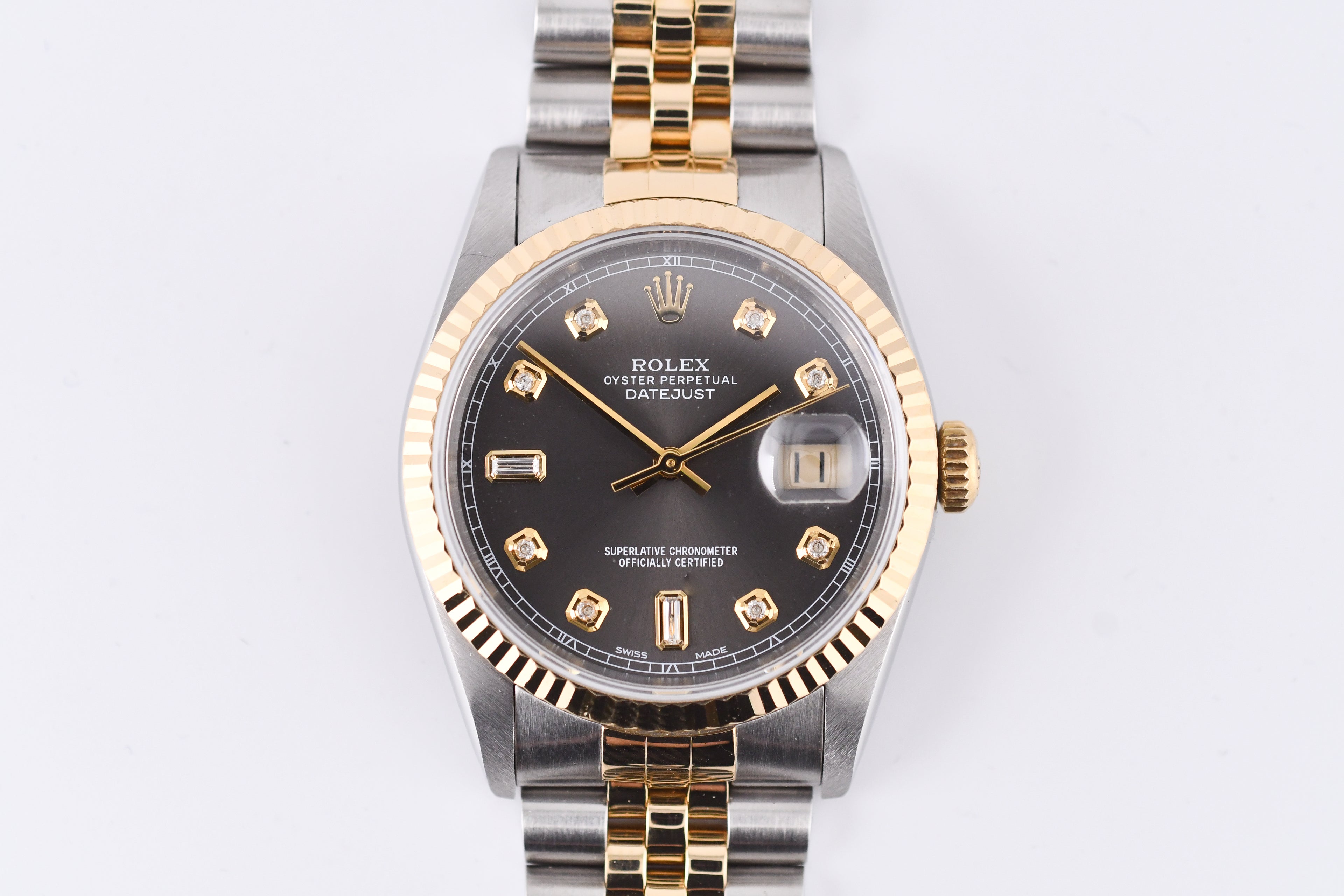 Rolex watch with gold and silver band on a white background