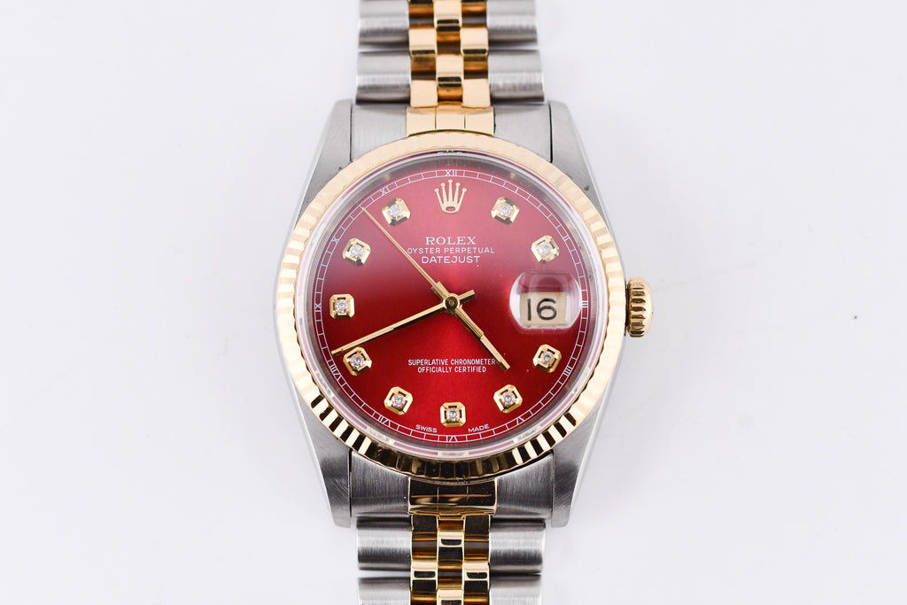 Watch with a red face and gold accents on a white background
