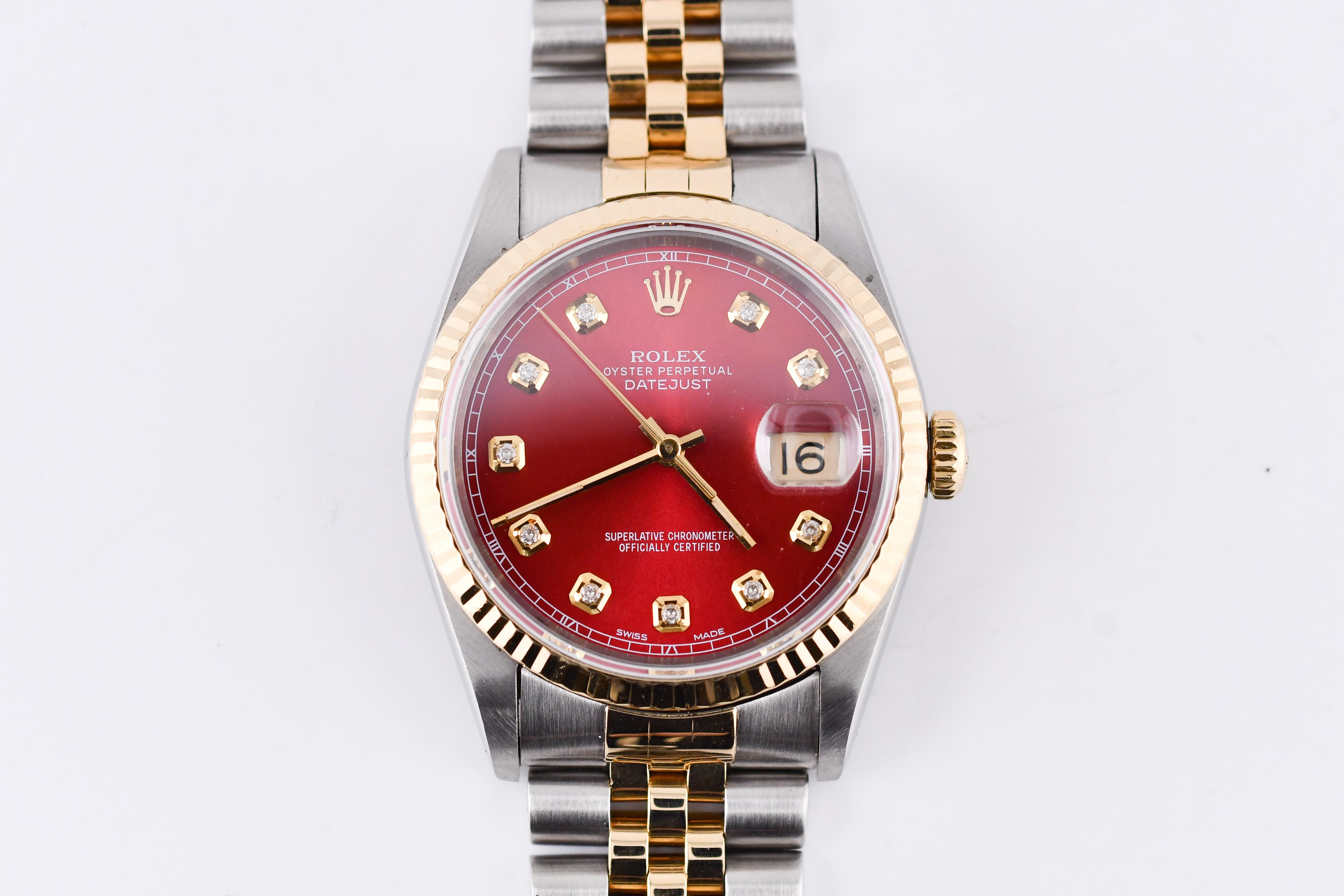 Watch with a red face and gold accents on a white background