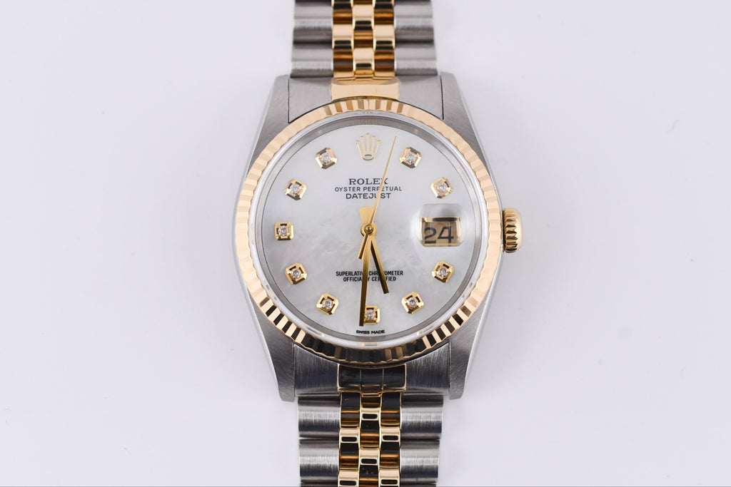 Rolex watch with silver and gold band on a white background