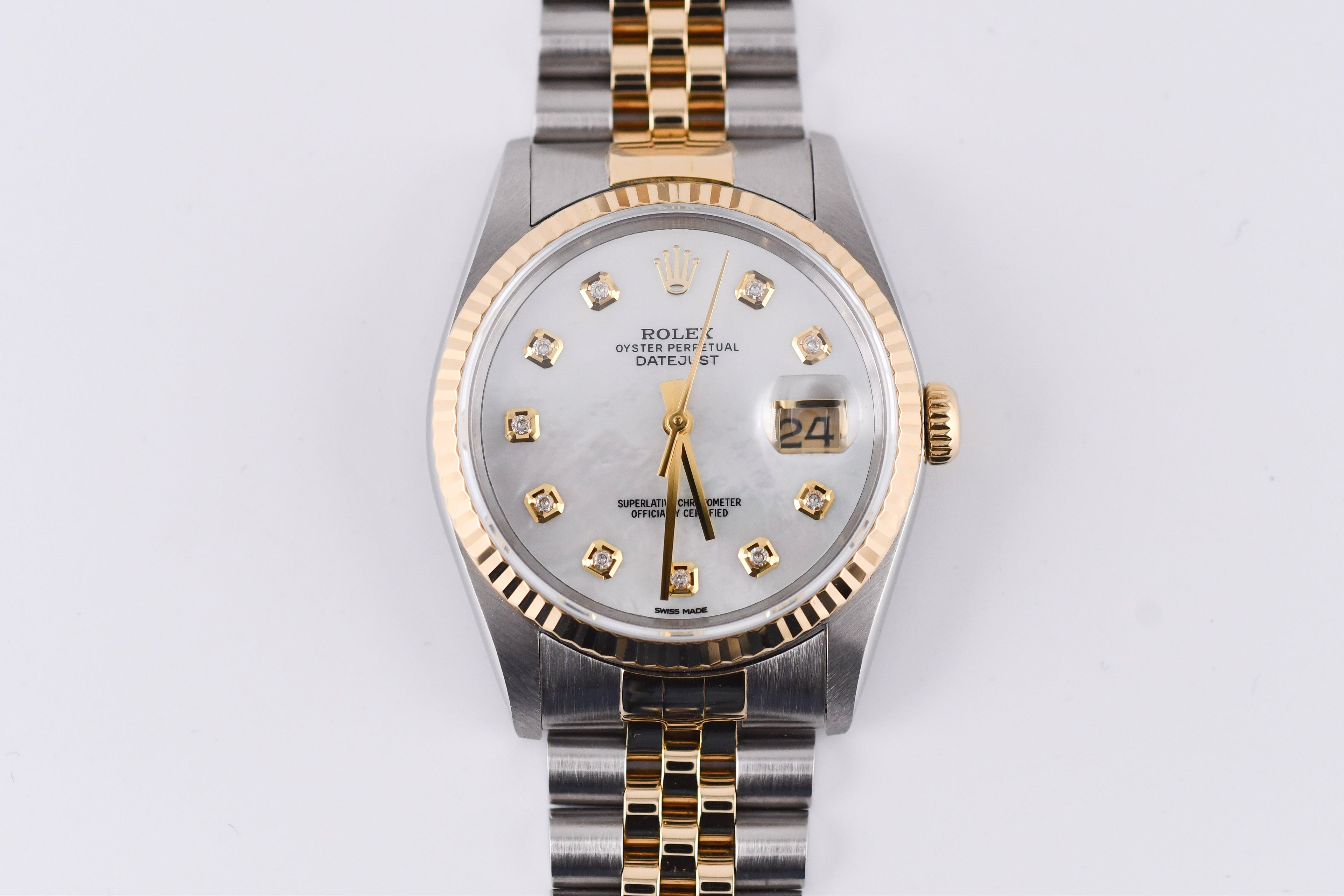 Rolex watch with silver and gold band on a white background