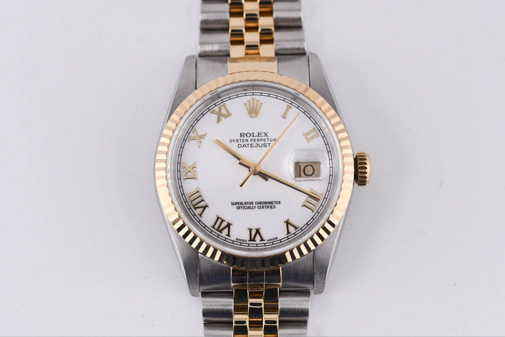 Rolex watch with gold and silver band on a white background