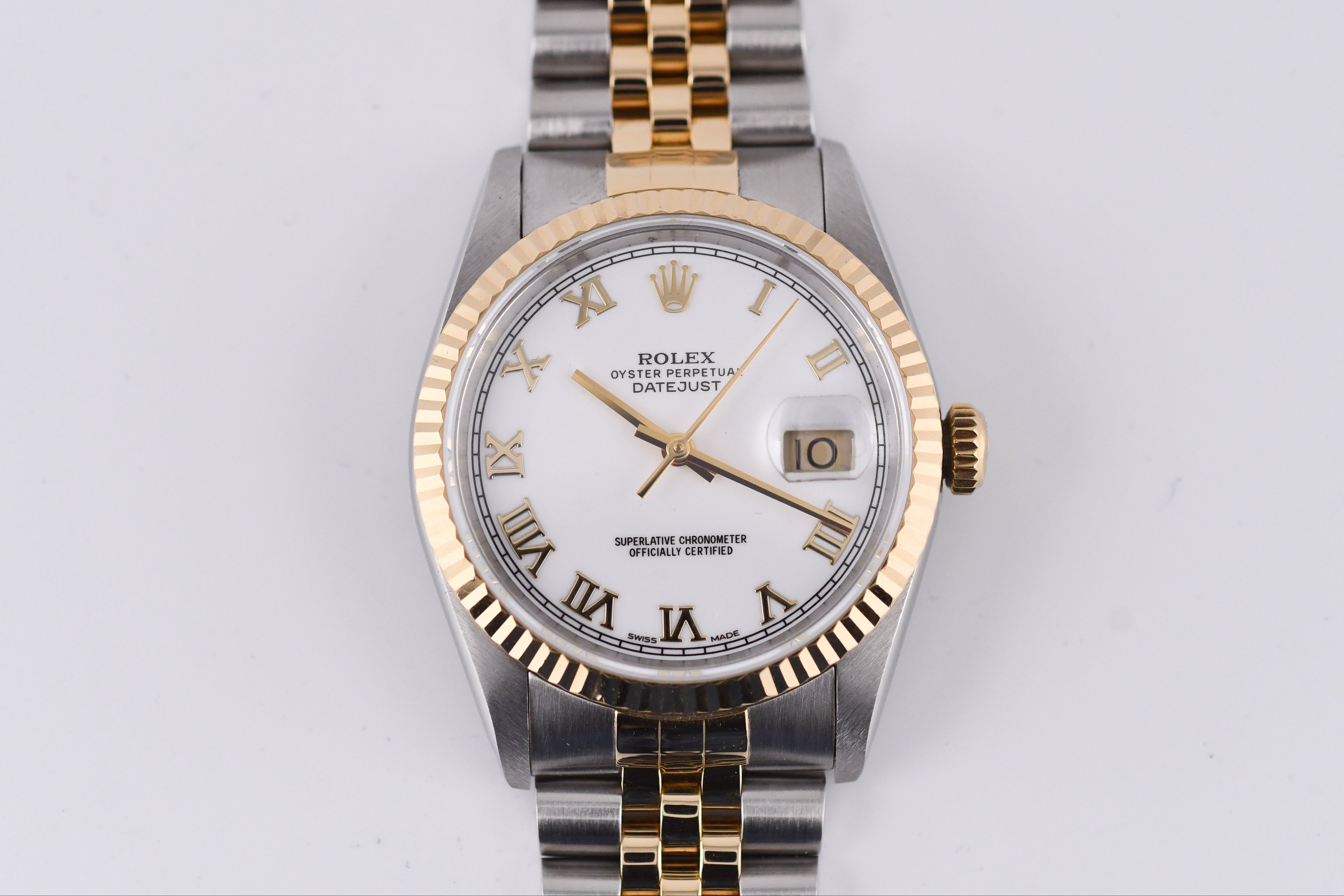 Rolex watch with gold and silver band on a white background