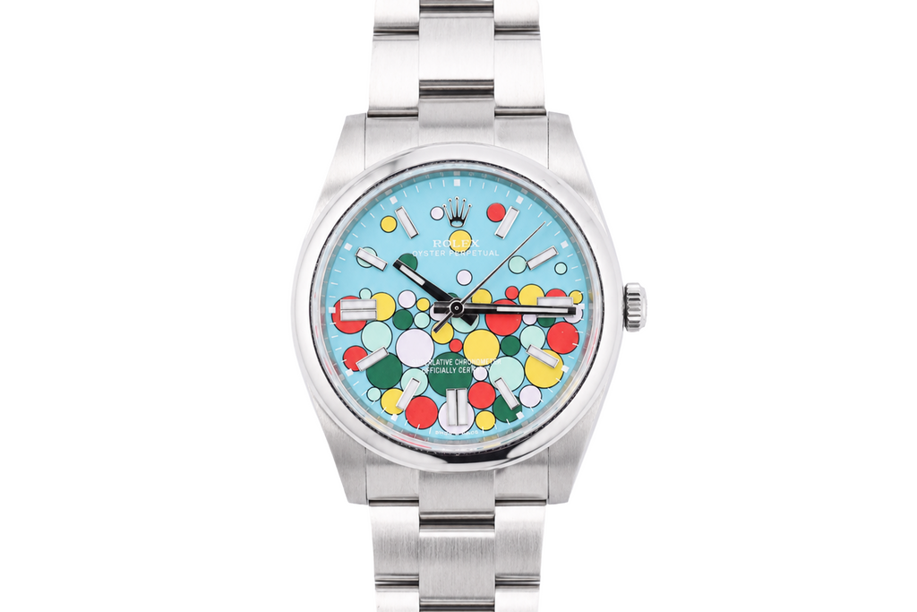 Silver watch with a colorful face on a white background