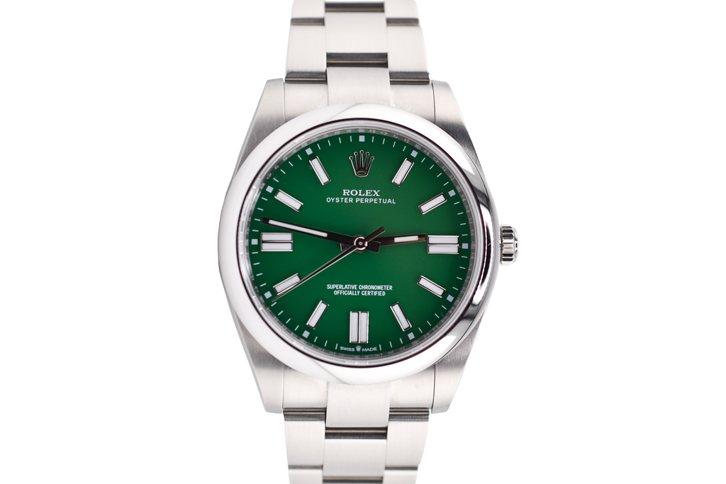 Silver watch with a green face on a white background
